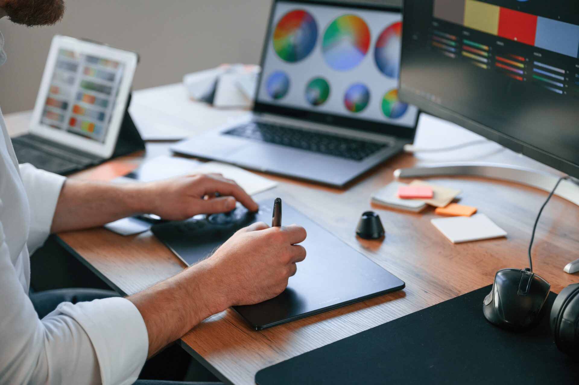 With graphic tablet. Close up view of designer's hands. Man in formal clothes is working in the modern office. Using computer.